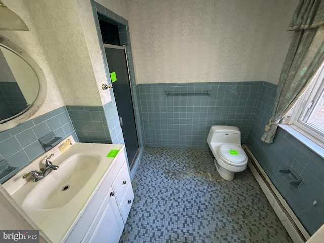 bathroom with tile walls, vanity, and an enclosed shower