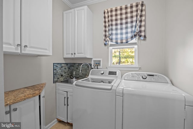 laundry area featuring crown molding, sink, cabinets, and independent washer and dryer