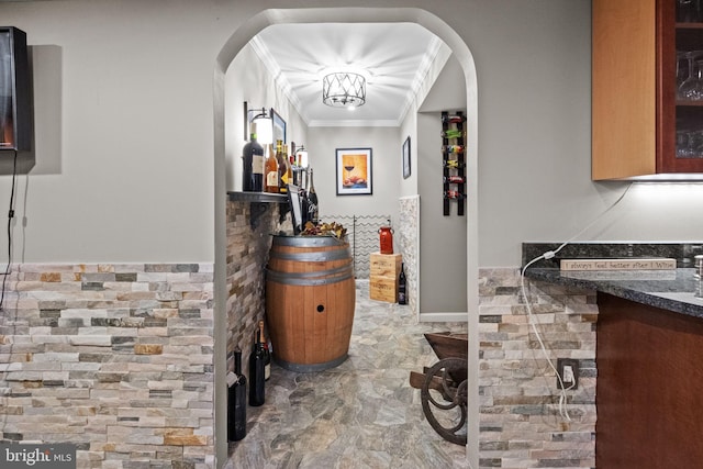 hall with an inviting chandelier and crown molding