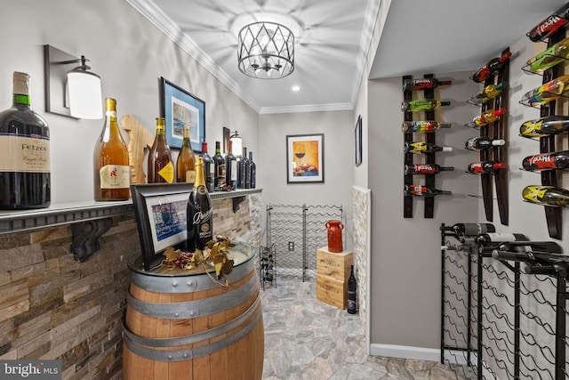 wine room featuring crown molding and an inviting chandelier