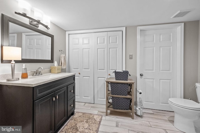 bathroom featuring vanity and toilet