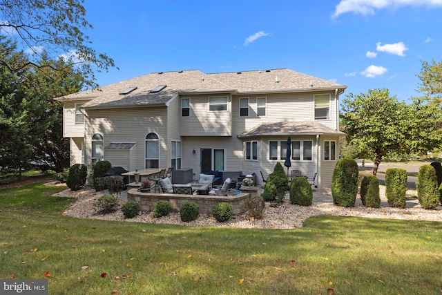 rear view of house with an outdoor hangout area, a patio area, and a lawn