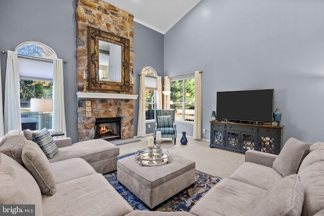 carpeted living room featuring a stone fireplace and high vaulted ceiling