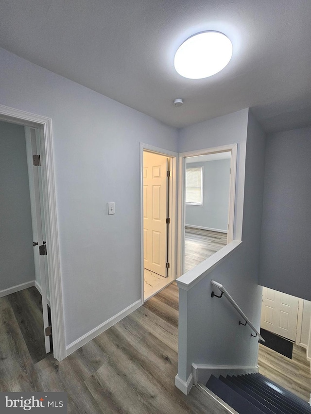 hallway with dark hardwood / wood-style floors