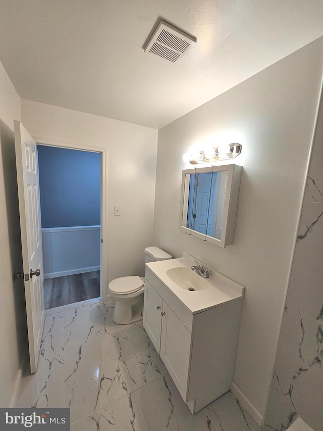 bathroom featuring vanity and toilet