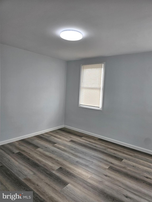 spare room with dark hardwood / wood-style floors