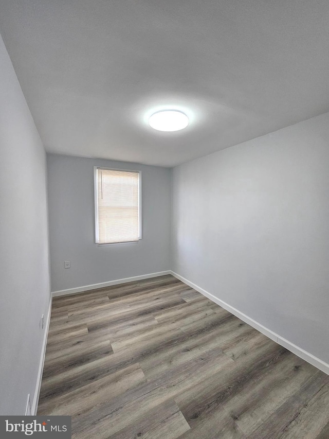 unfurnished room featuring hardwood / wood-style flooring