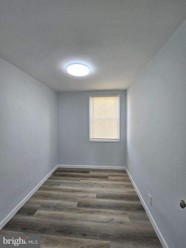 spare room featuring dark wood-type flooring