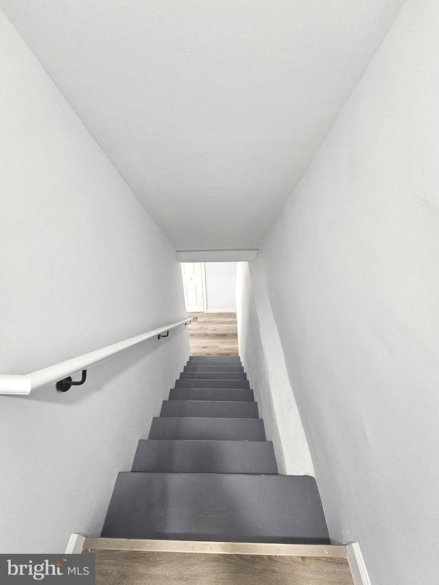 stairs featuring hardwood / wood-style flooring