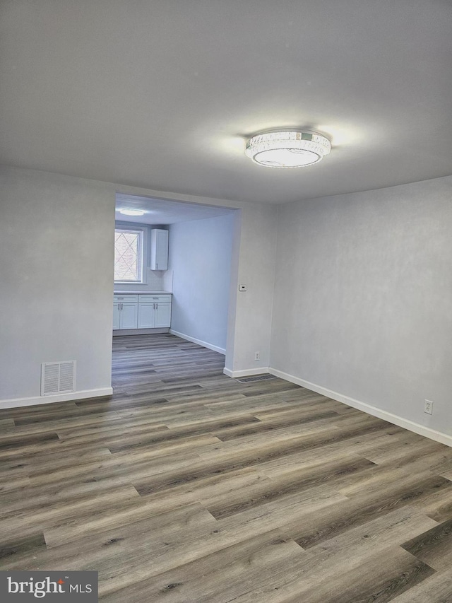 unfurnished room featuring dark hardwood / wood-style flooring