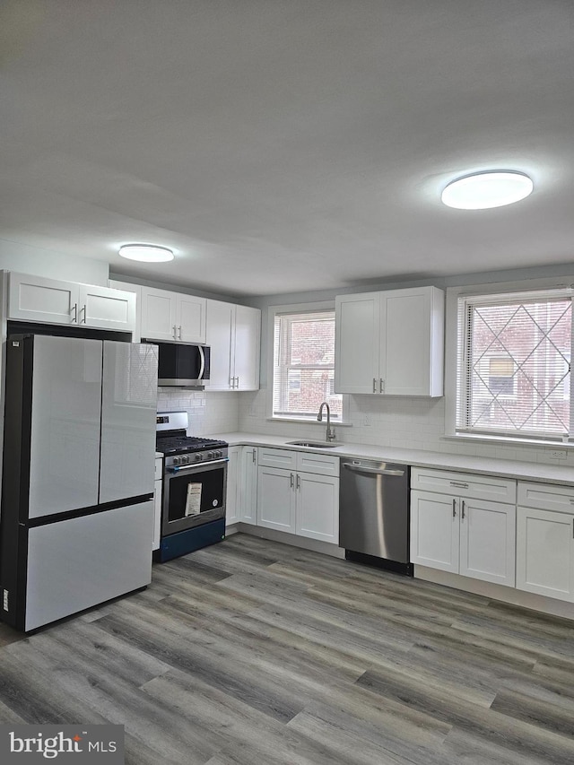 kitchen featuring white cabinetry, sink, dark hardwood / wood-style floors, and appliances with stainless steel finishes