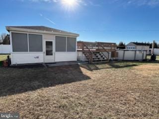 rear view of property with a pool side deck and a sunroom