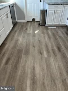 room details featuring dark hardwood / wood-style floors and white cabinetry