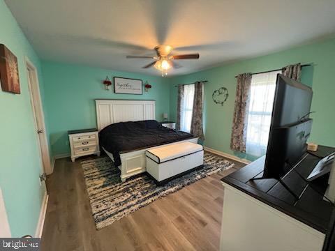 bedroom with hardwood / wood-style floors and ceiling fan