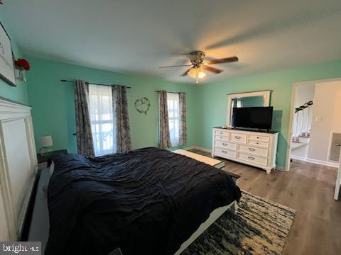 bedroom featuring ceiling fan and hardwood / wood-style floors