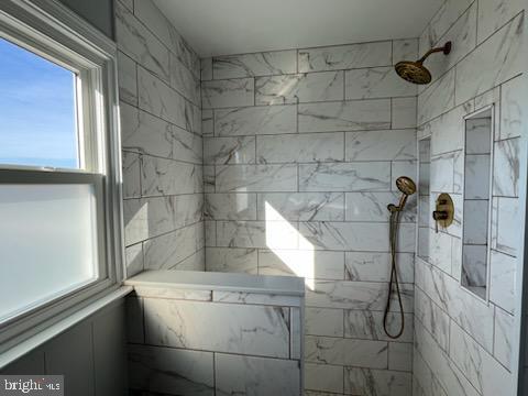 bathroom featuring a tile shower