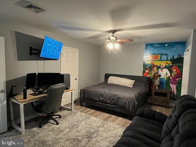 bedroom with ceiling fan and hardwood / wood-style floors