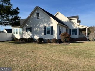 view of side of property with a yard