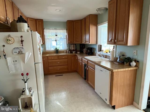 kitchen with white appliances and sink