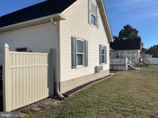 view of side of property with a lawn