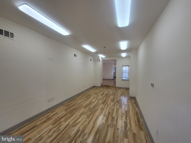 spare room with hardwood / wood-style floors