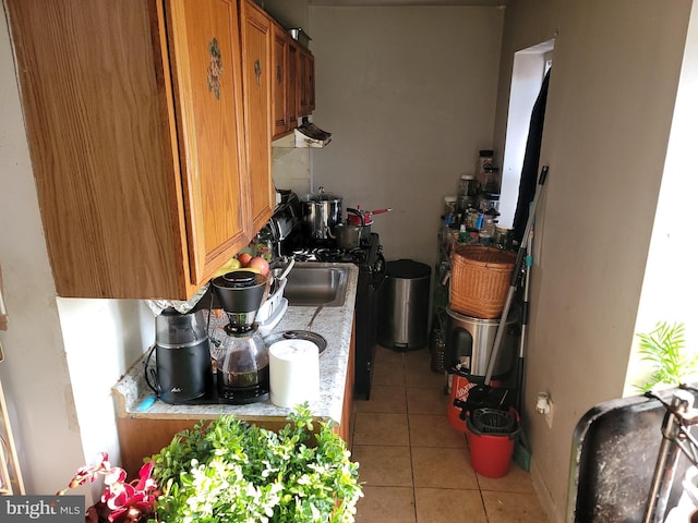 kitchen featuring sink and light tile patterned floors