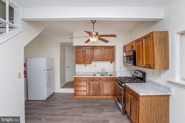 kitchen featuring dark hardwood / wood-style floors, ceiling fan, sink, and appliances with stainless steel finishes