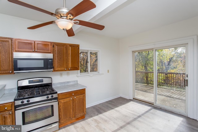 kitchen with ceiling fan, light hardwood / wood-style floors, and stainless steel appliances