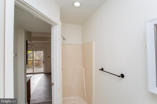 bathroom featuring hardwood / wood-style floors and walk in shower