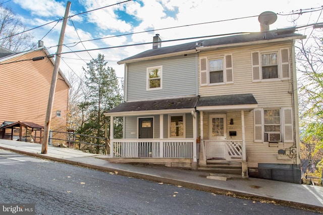 view of front of house with a porch and cooling unit