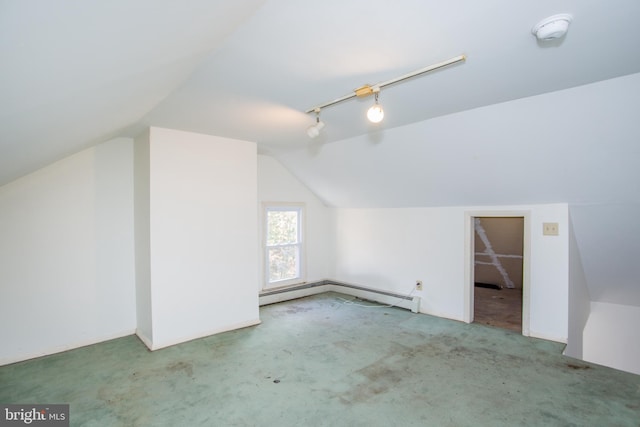 additional living space with carpet, vaulted ceiling, and a baseboard heating unit