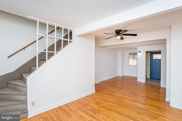 unfurnished living room with ceiling fan and wood-type flooring