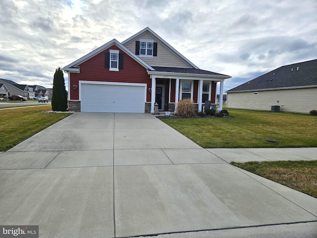 view of front of house with central AC unit, a garage, covered porch, and a front lawn