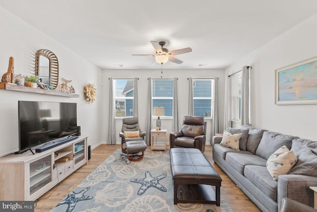 living room featuring light hardwood / wood-style flooring and ceiling fan