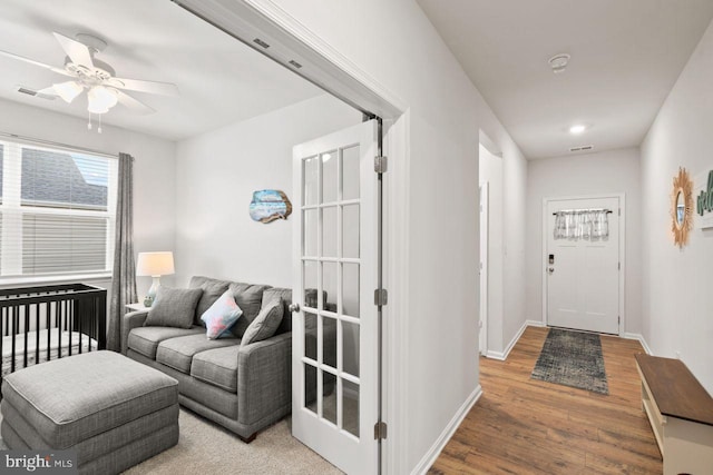 interior space with ceiling fan, french doors, and hardwood / wood-style flooring