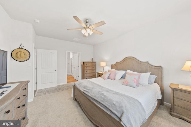 carpeted bedroom with ceiling fan and connected bathroom