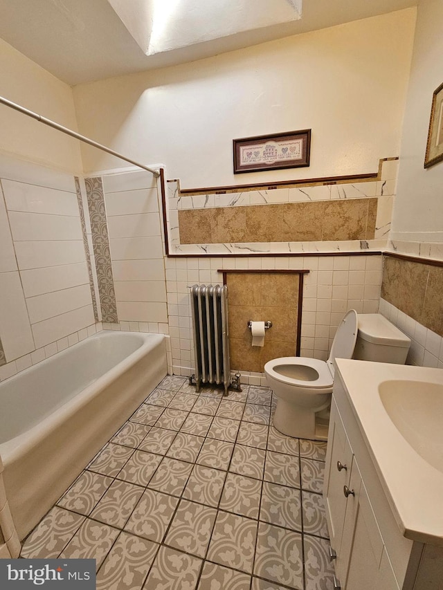 full bathroom featuring radiator heating unit, tile patterned flooring, bathing tub / shower combination, toilet, and tile walls