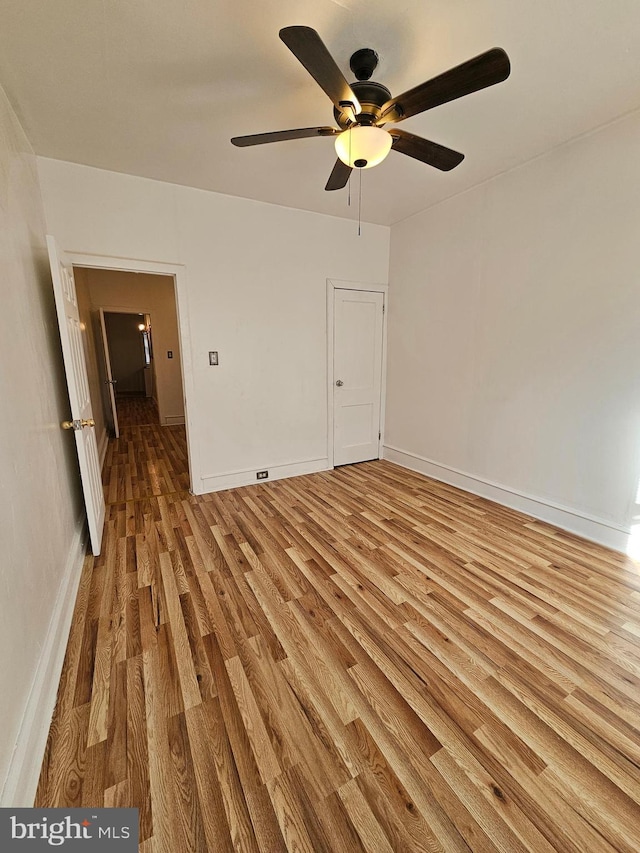 spare room featuring wood-type flooring and ceiling fan