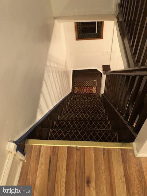 stairs with hardwood / wood-style floors