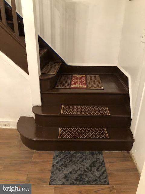 stairway featuring hardwood / wood-style flooring