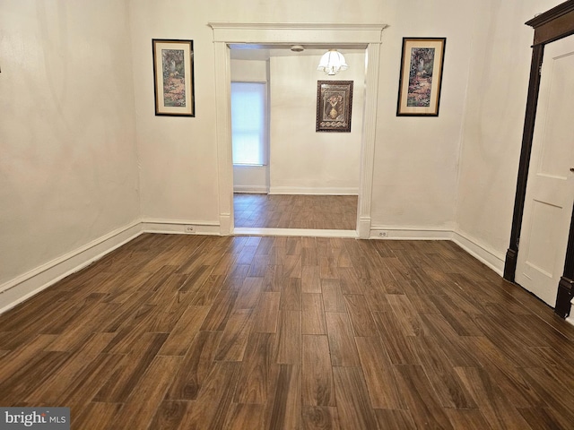 spare room with dark hardwood / wood-style flooring