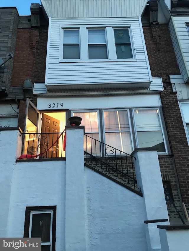 view of side of home with a balcony