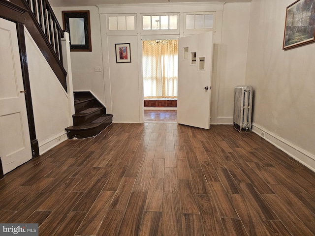 foyer featuring dark hardwood / wood-style flooring and radiator