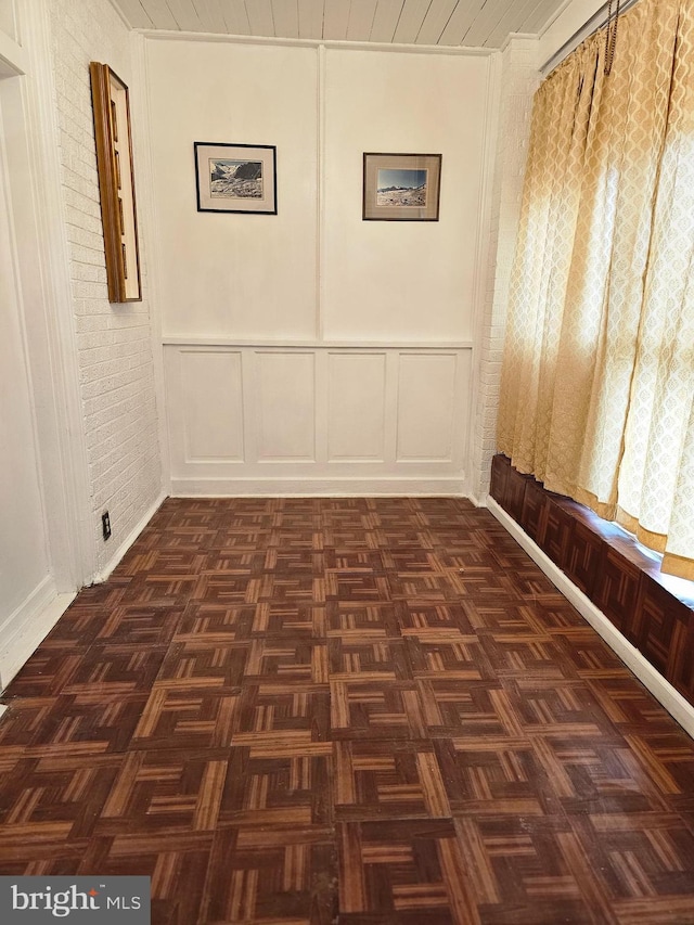 empty room with dark parquet flooring