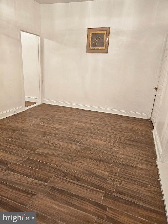 unfurnished room with dark hardwood / wood-style floors