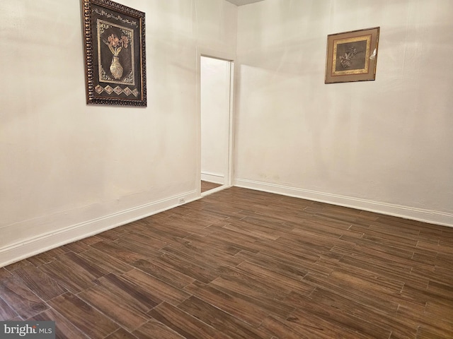 spare room with dark hardwood / wood-style floors