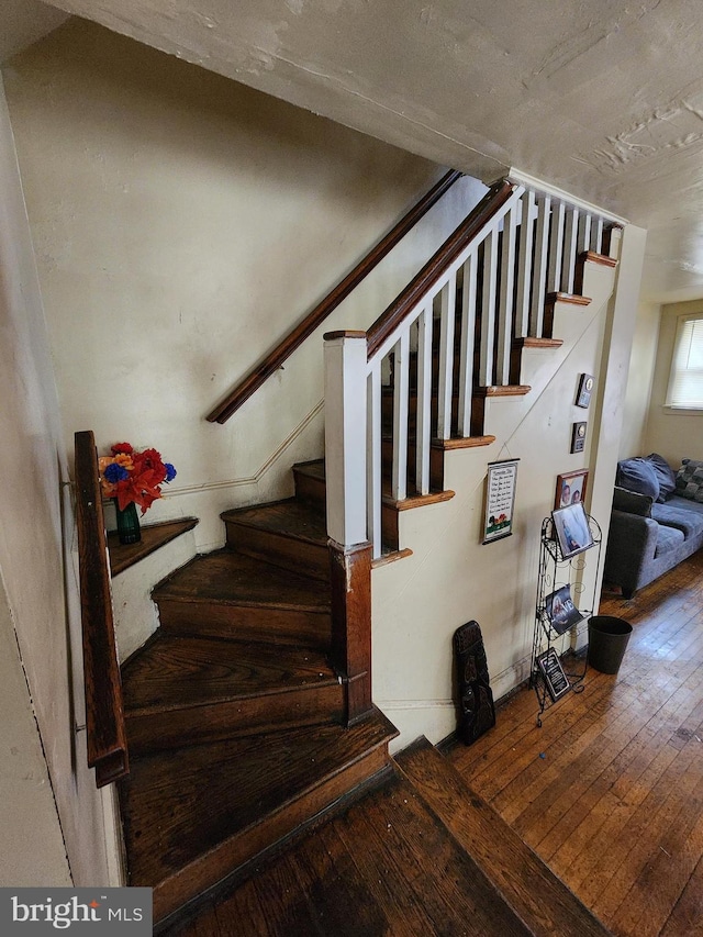 stairs with wood-type flooring