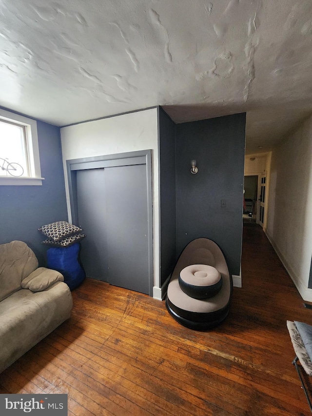 interior space featuring wood-type flooring and a textured ceiling