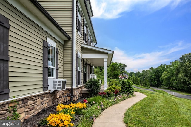 view of side of home with a yard and cooling unit