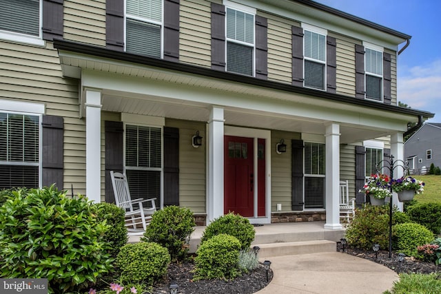 view of exterior entry with covered porch